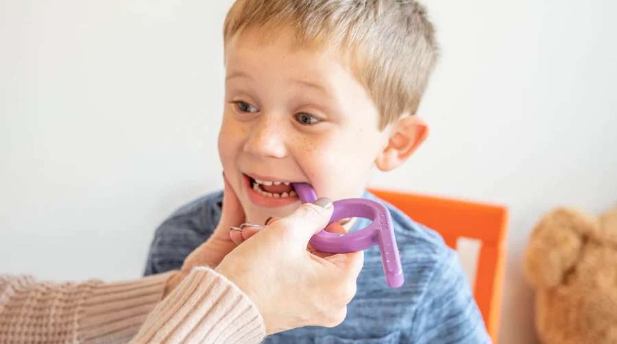 Child in speech therapy session at Blooming Words